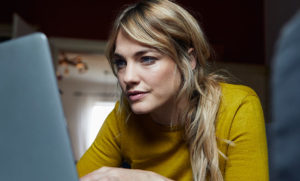 women stares into laptop